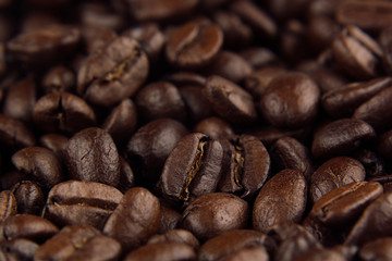 Roasted coffee beans closeup top view as background.