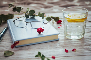 book glasses and flower petals