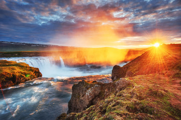 Godafoss waterfall at sunset. Fantastic landscape. Beautiful cumulus clouds. Iceland Europe
