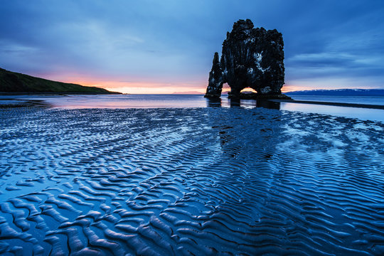 Hvitserkur 15 m height. Is a spectacular rock in the sea on the Northern coast of Iceland.  this photo  reflects in the  water after the midnight sunset.