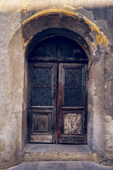 Fototapeta na wymiar Old weathered wooden door, closed house entrance