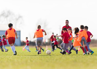 Obraz na płótnie Canvas Kids soccer football - children players match on soccer field