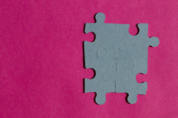 Jigsaw puzzle pieces on bright pink background