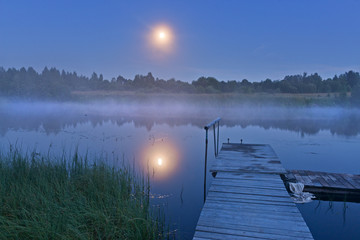 Evening mist over river and  full moon.