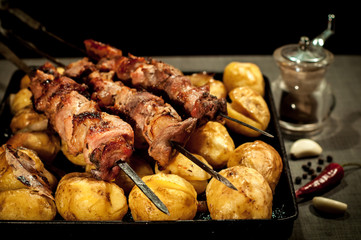 Barbecue meat with baked potato closeup