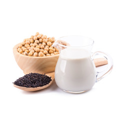 Soy milk in a glass jar and soybeans, black sesame Isolated on white background