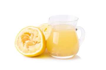 glass bowl of freshly squeezed lemon juice, lemon squeezer and ripe lemons on white background