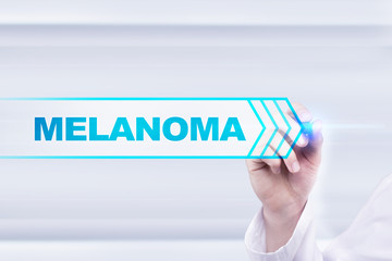 Naklejka premium Medical doctor drawing melanoma on the virtual screen.