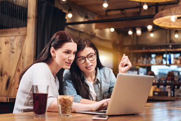 Relaxed girls sitting in pub