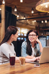 Beautiful smiling women looking to each other