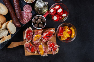 Spanish tapas with slices jamon serrano and grilled pepper. Also