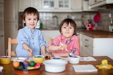 Two boys, coloring eggs for Easter