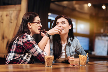 Dreamy girls trying cherry liqueur