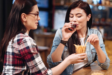Enigmatical female taking potatoes from glass