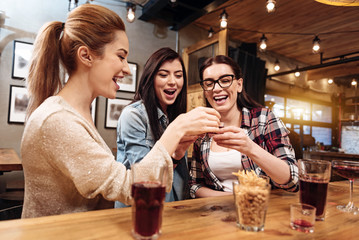 Smiling young women clinking glasses