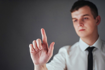 Businessman hand pointing on empty space on black background