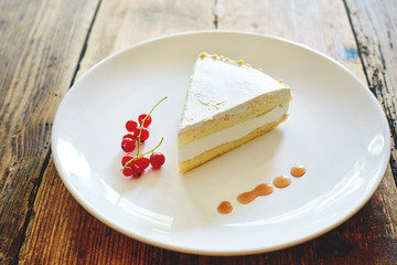 Dietary homemade cheesecake on a plate on a wooden background.