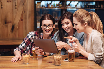 Pretty blonde pointing on screen of tablet