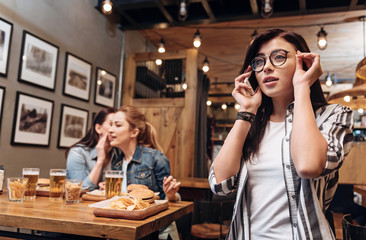 Stylish brunette touching her new glasses