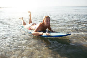Beautiful sexy surfer girl on the beach