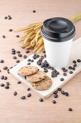 Coffee cup and coffee beans on wooden background