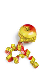 Red-yellow Apple with a measuring tape on a white background.