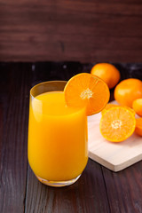 Orange juice on wooden background
