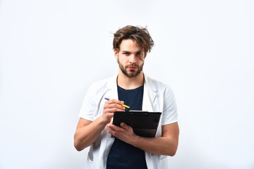 Bearded caucasian doctor or postgraduate student with clipboard and pen