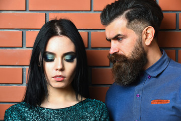 bearded man and pretty sexy woman on brick wall