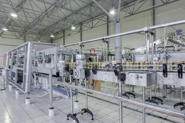 conveyor belt in motion at production and bottling of drinks in tin cans. production and bottling of drinks in tin cans