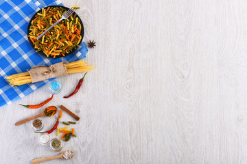Dried italian pasta on blue plaid tablecloth