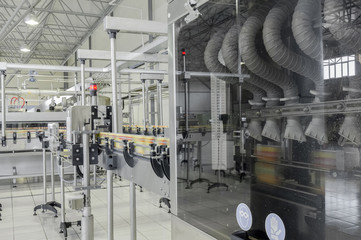 conveyor belt in motion at production and bottling of drinks in tin cans. production and bottling of drinks in tin cans