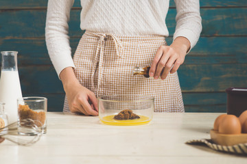 House wife wearing apron making. Steps of making cooking chocolate cake.