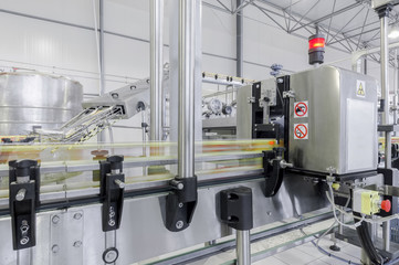 close-up of conveyor belt in motion at production and bottling of drinks in tin cans. production and bottling of drinks in tin cans
