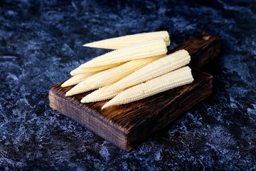 Baby corn cobs on kitchen table