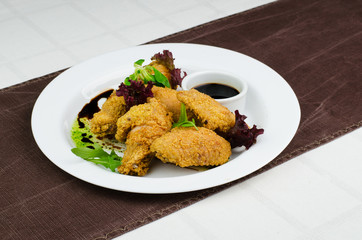 Crispy Fried Chicken Wings With Sauce On White Plate