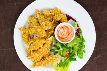 Fried Chicken Strips With Cornflakes And Sauce On White Plate