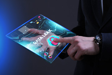 Business, Technology, Internet and network concept. Young businessman working on a virtual screen of the future and sees the inscription: Data leak