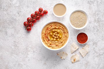 Hummus middle eastern homemade appetizer healthy vegan chickpeas paste dip snack flat lay with natural ingridients, tahini, paprika, olive oil, pitta. Healthy vegetarian diet nutrition protein food