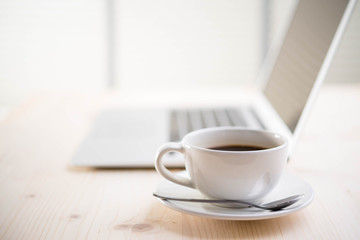 coffee and laptop on wooden table