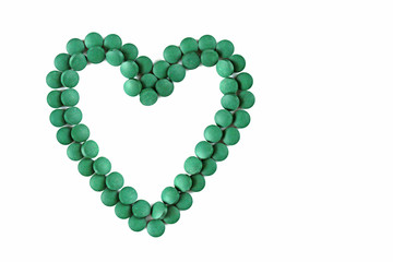   spirulina tablets on white background. Heart