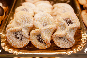 Cookies with a filling of jam in the form of figures eight sprinkled with powdered sugar