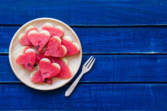 Slices of watermelon on blue rustic wooden table background