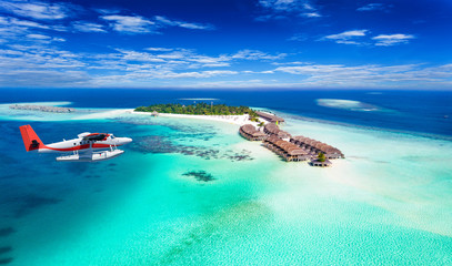 Wasserflugzeug fliegt über Malediven Insel - obrazy, fototapety, plakaty