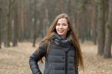 Portrait of a girl in a gray jacket in the open air