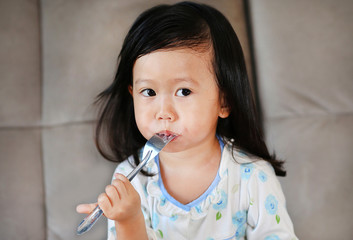 Portrait of beautiful girl with fork while eating