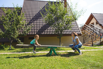 Woman and Girl Playing at Yard