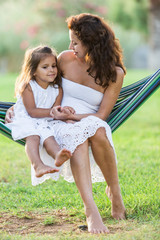 Mother and daughter are resting in the country side.