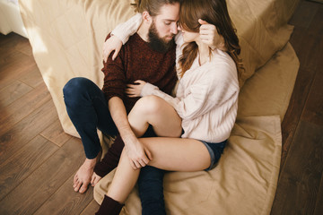 Tender embracing couple on floor