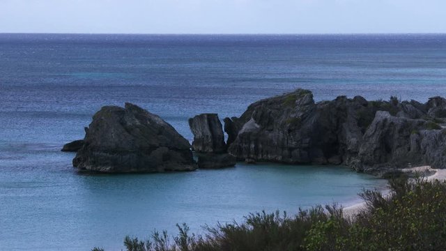 Choppy sea in Bermuda, with view of empty peaceful beach.